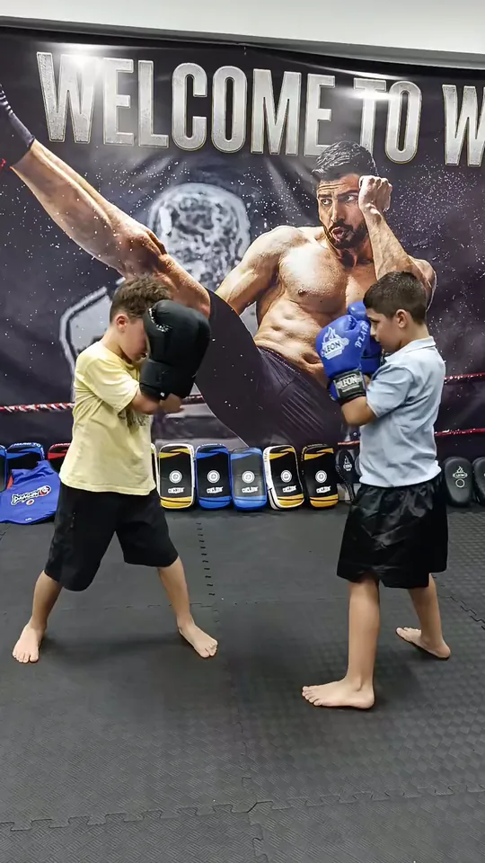 Hoca ellik tutuyor, bir çocuk yumruk atıyor